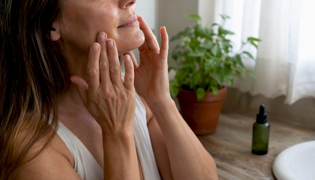 Woman applying anti-aging serum on face