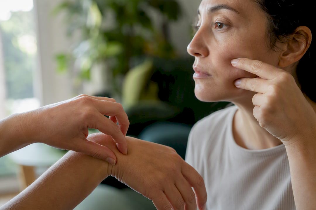 Close-up of pinch test on face and hand skin