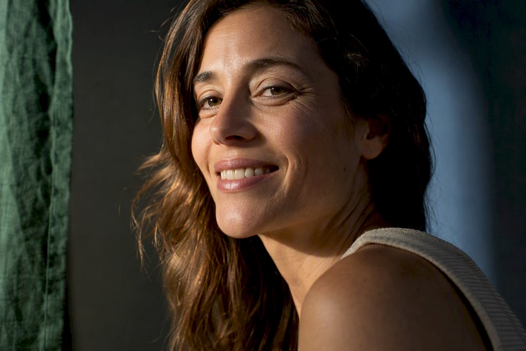 Woman smiling with visible nasolabial folds