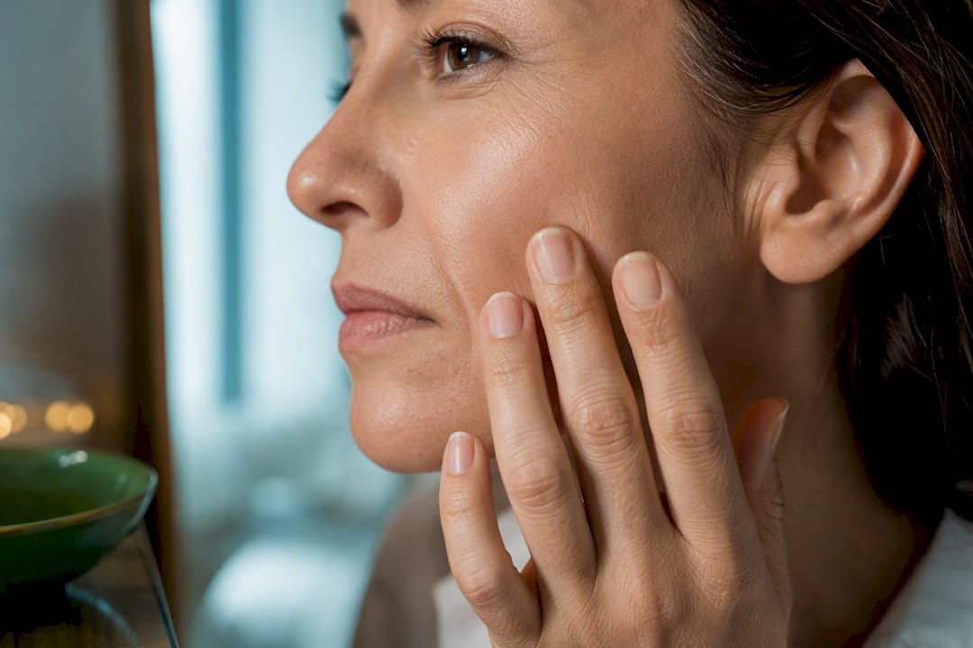 Woman examining a nasolabial fold