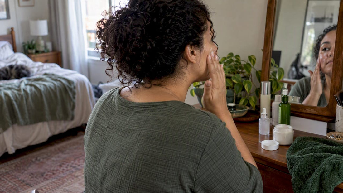 Woman sealing damp skin with moisturizer